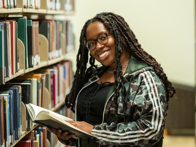 Kean student peruses the campus library