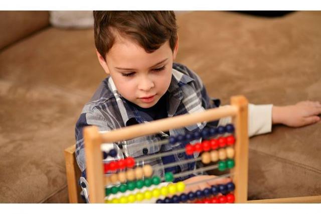 Autistic child uses abacus for treatment